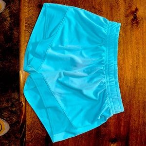 Neon blue shorts, brand is bcg.